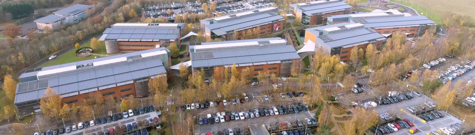 Aerial view of 7 large office blocks and attached car parks
