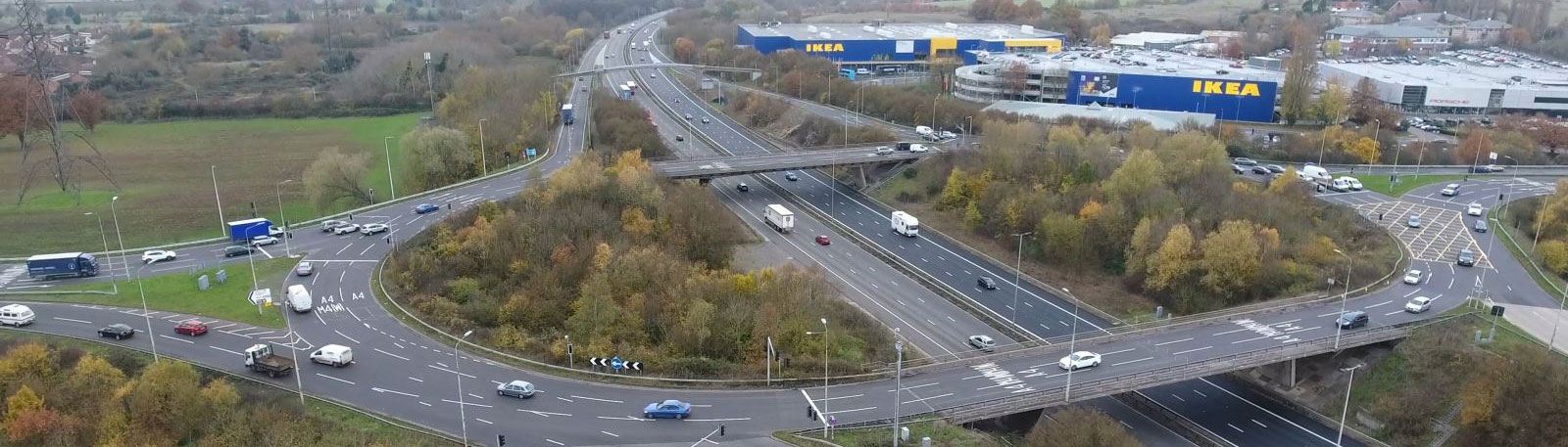 Aerial view of a roundabout over a motorway with an ikea next to it
